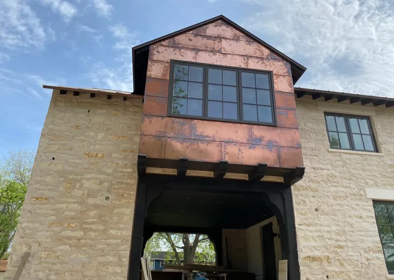 Copper metal panel facade on a stone building for Metal Roof Coating in Kalispell