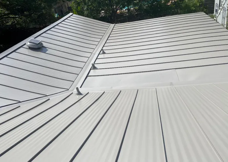 Solar attic fan installed on a metal roof for Roof Ventilation in Kalispell